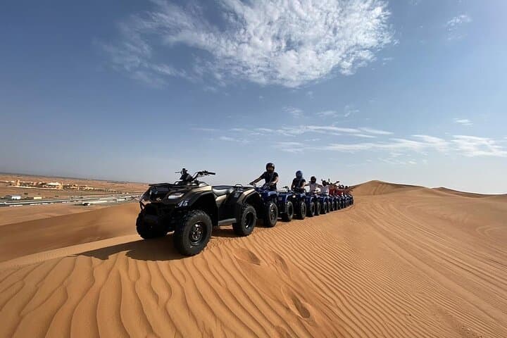Dubai Red Dunes Quad Safari: Sunset Quad Biking, Camel Ride & BBQ Desert Camp