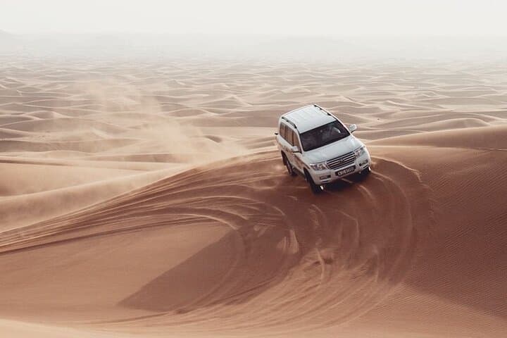 Dubai Desert Safari: Dune Bashing, Sandboarding & Camel Ride with BBQ Dinner