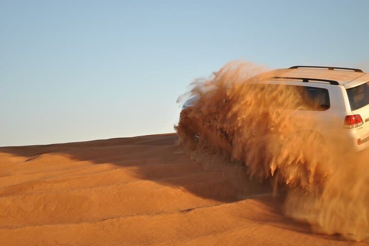 Evening Dubai Desert Safari: Dune Bashing, Sandboarding & BBQ Under the Sunset