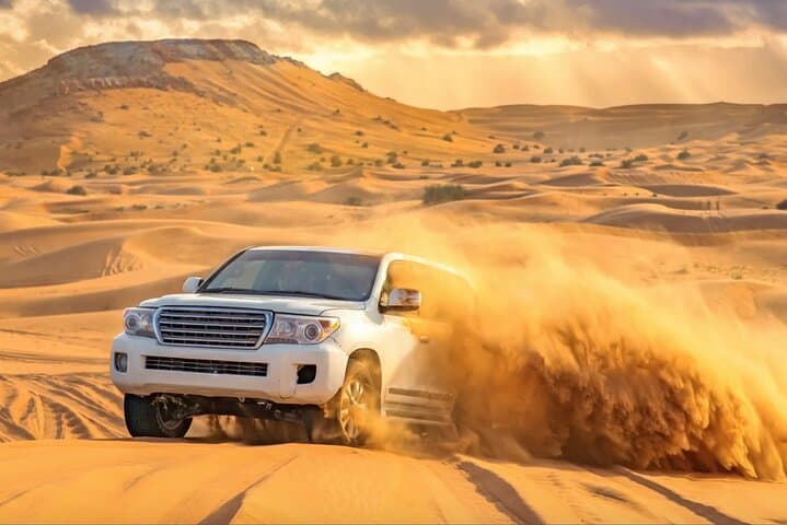 Sunset Dunes: Dubai Desert Safari with Dune Bashing, Camel Ride & BBQ