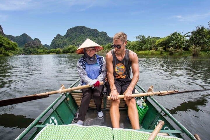 Day Trip to Trang An, Hoa Lu & Mua Cave from Hanoi — Boat Caves and Summit Views photo 2