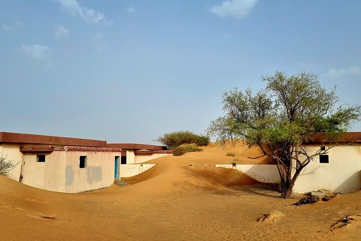 Al Madam Ghost Village Desert Safari: Dune Bashing & Sandboarding from Dubai