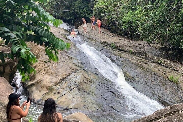 El Yunque Waterfall Slides & Luquillo Beach — Rainforest Adventure with Drinks