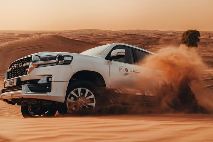 Deluxe Sunset Desert Safari Dubai — Dune Bashing, Sandboarding & BBQ Experience
