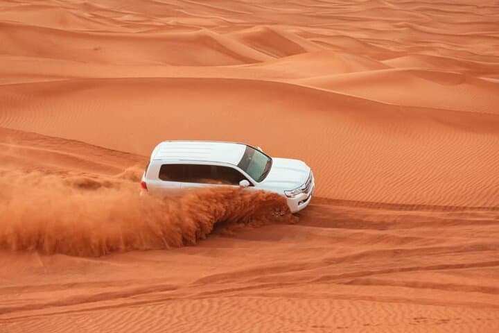 Abu Dhabi to Dubai Desert Safari: Dune Bashing, Sunset & Bedouin Camp Experience photo 1
