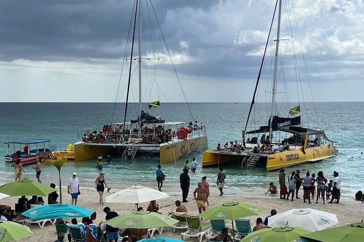 Negril Private Day Tour: ATV Ride, 7-Mile Party Catamaran & Rick's Cafe Sunset