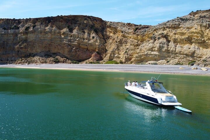 Full-Day Private Yacht Charter from Lagos: Tapas, Paddleboarding & Coastal Caves