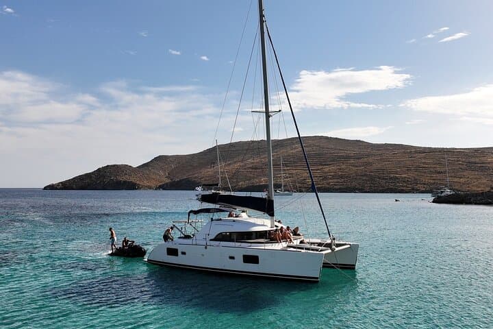 Sunlit Catamaran Cruise from Mykonos: Delos, Rhenia & Water Toys