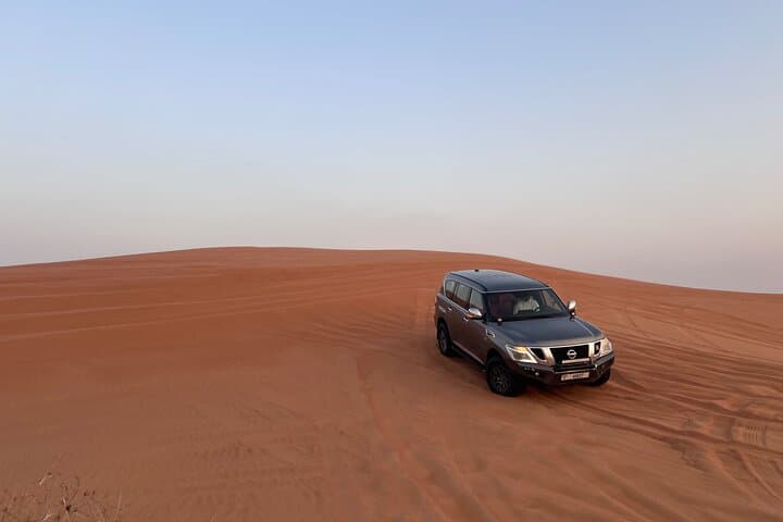 Dubai Evening Red Sand Safari: Dune Bashing, Camel Ride, Sandboarding & BBQ