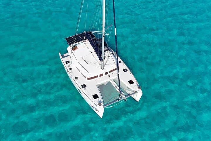 Private Catamaran Tour to Isla Mujeres: Full-Day Sail, Snorkel & Beach Club Experience