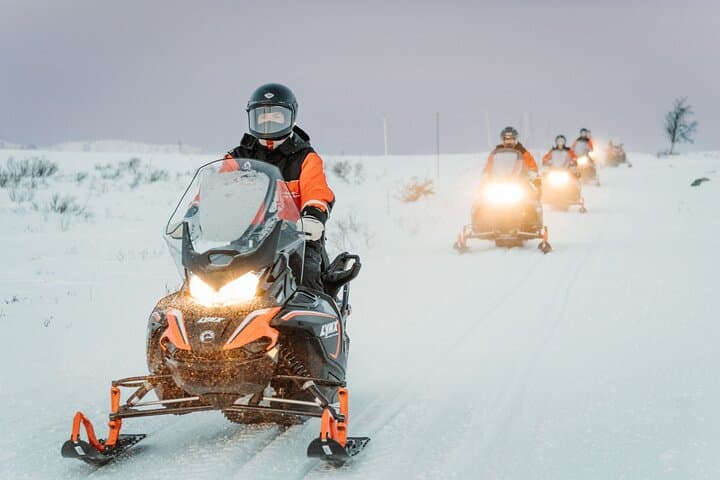 Explore Arctic Wilderness: Snowmobile and Icefishing Adventure in Alta