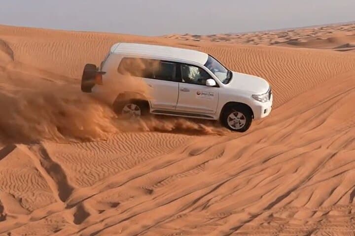 Dubai Desert Safari: Dune Bashing, Sandboarding & Bedouin BBQ Experience