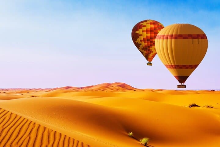 Sunrise Hot Air Balloon Over Dubai Desert Reserve — 60-Min Flight, Falconry & Breakfast