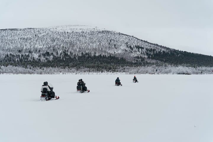 Explore Swedish Lapland: Thrilling Snowmobile Tour on the Frozen Torne River