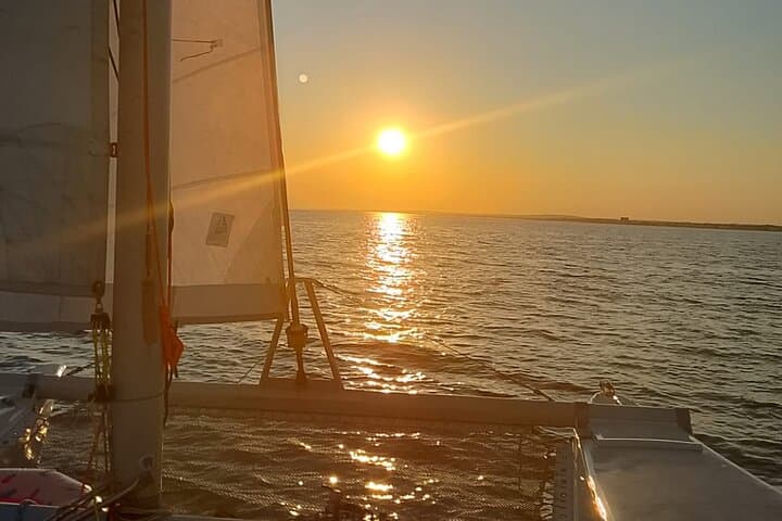 Sunset Catamaran Adventure in Porto Cesareo: Sail, Snorkel & Local Flavors