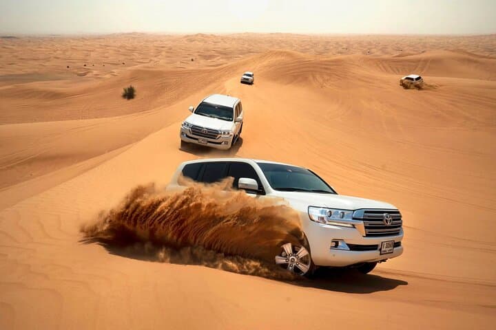 Premium Dubai Desert Safari and ATV Experience: Luxury Camp, Dune Bashing & Sandboarding