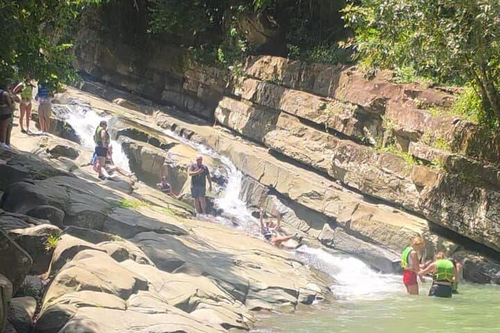 El Yunque Waterslides & Luquillo Beach Day Tour: Rainforest Slides, River Swim & Local Eats