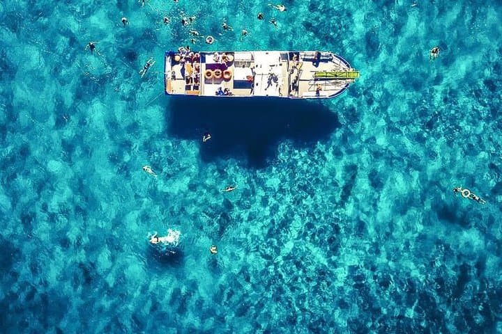 Ibiza Beach Hopper: Boat Tour with Open Bar, Paddleboarding & Snorkeling