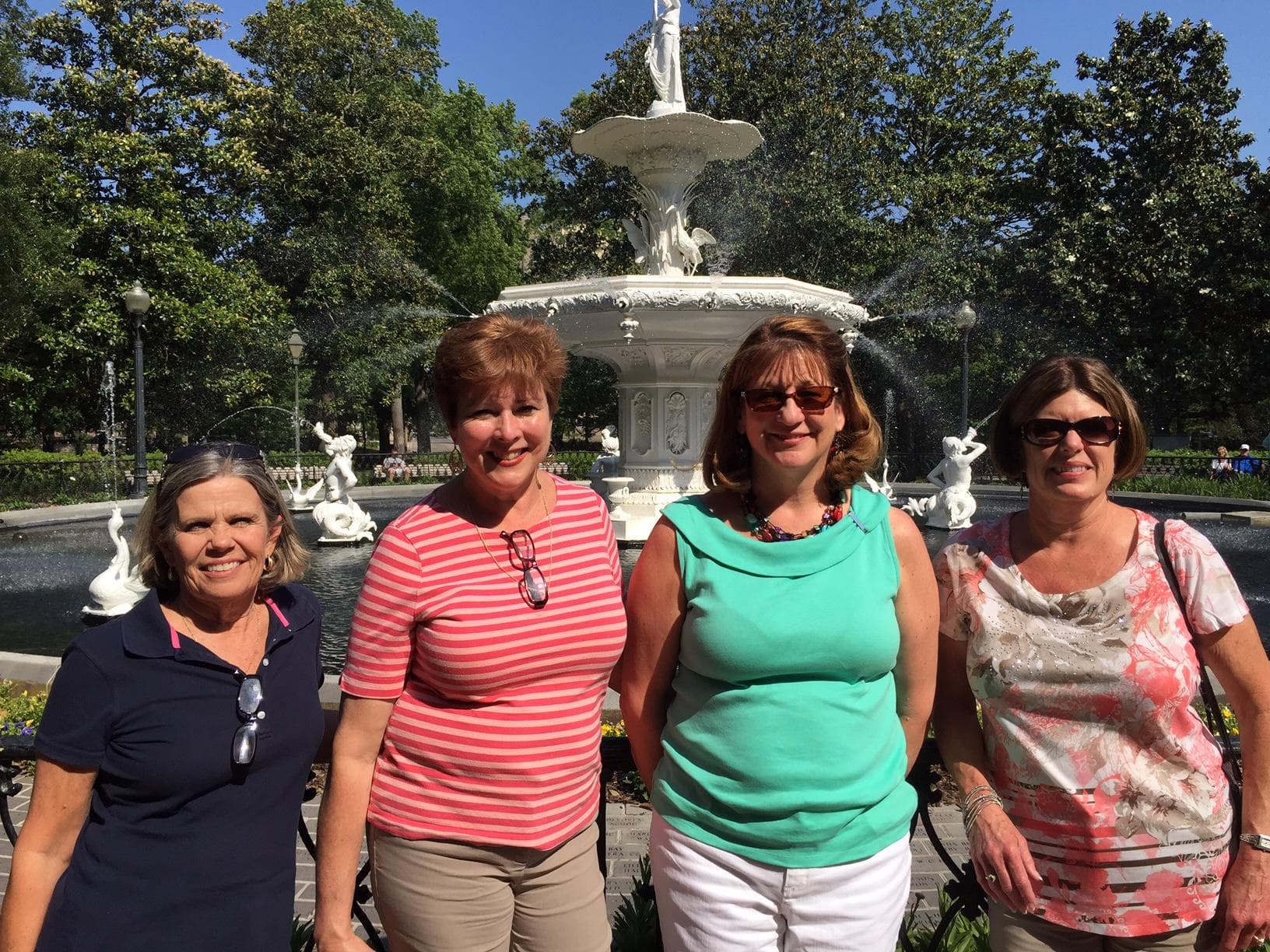 Women group smiling by Forsyth Park fountain on walking tour
