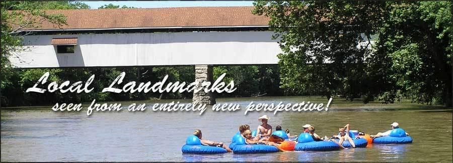 Guided kayak trip passing riverside bridge on White River