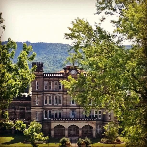 Historic West Virginia penitentiary exterior with mountain views