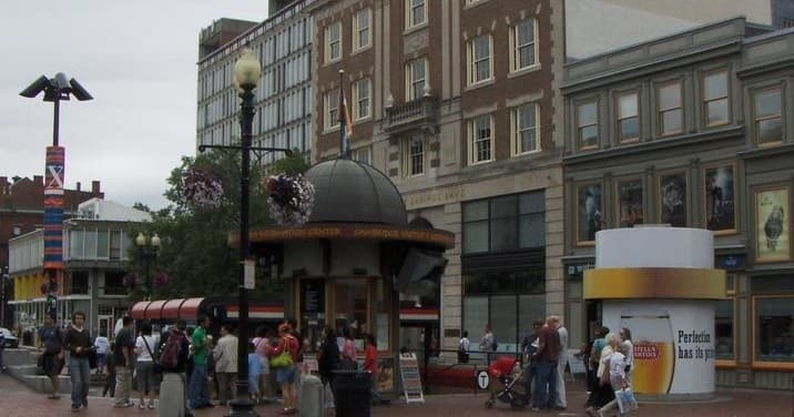 Historic downtown Boston street with outdoor kiosks, shoppers, tour vibe