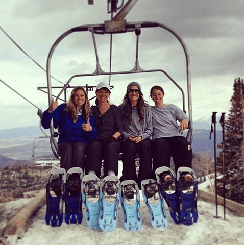 Friends on ski lift with skis in Park City ski resort
