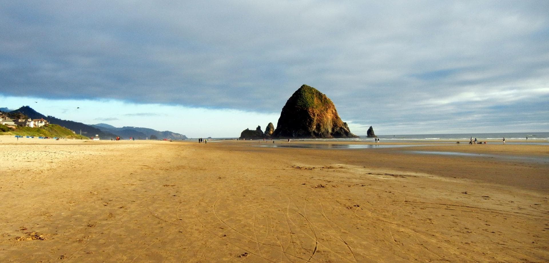 Wide sandy beach leading to Haystack Rock on Oregon shoreline