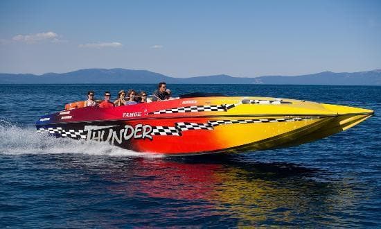 Yellow speedboat cutting across blue water in high-speed thrill ride