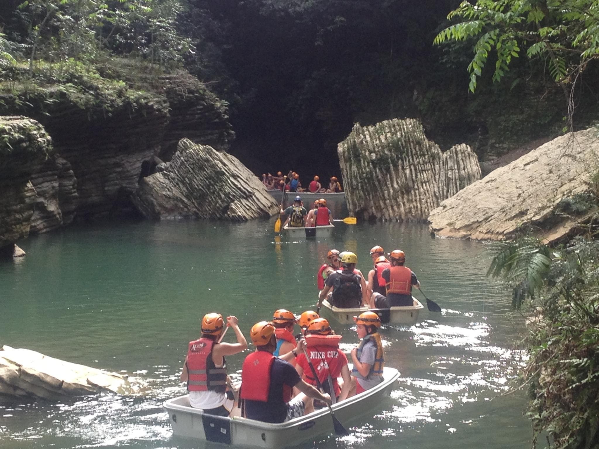 Guided rafting trip through jungle canyon in inflatable boats
