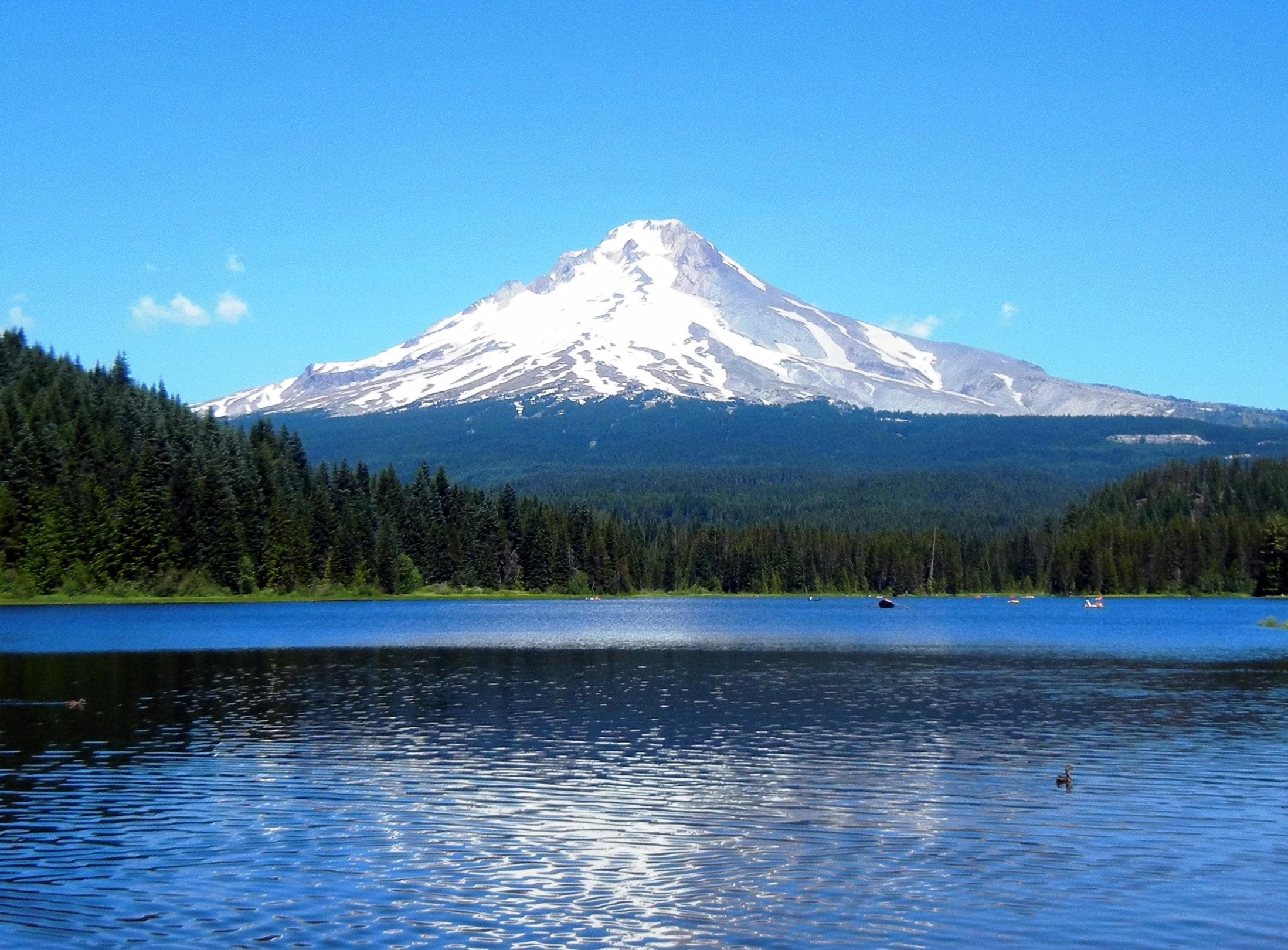 Mountain peak reflected in tranquil alpine lake at sunrise