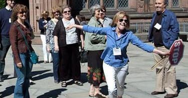 Leader guiding urban walking tour near historic cathedral plaza