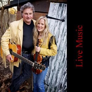Folk musicians duo playing guitars outdoors by rustic barn