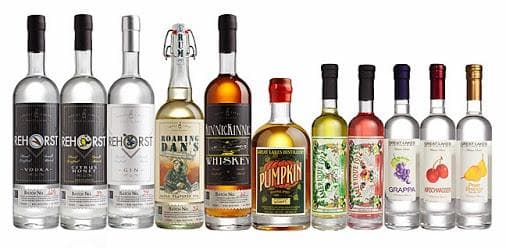 Product lineup of bottled spirits and flavored vodkas on white