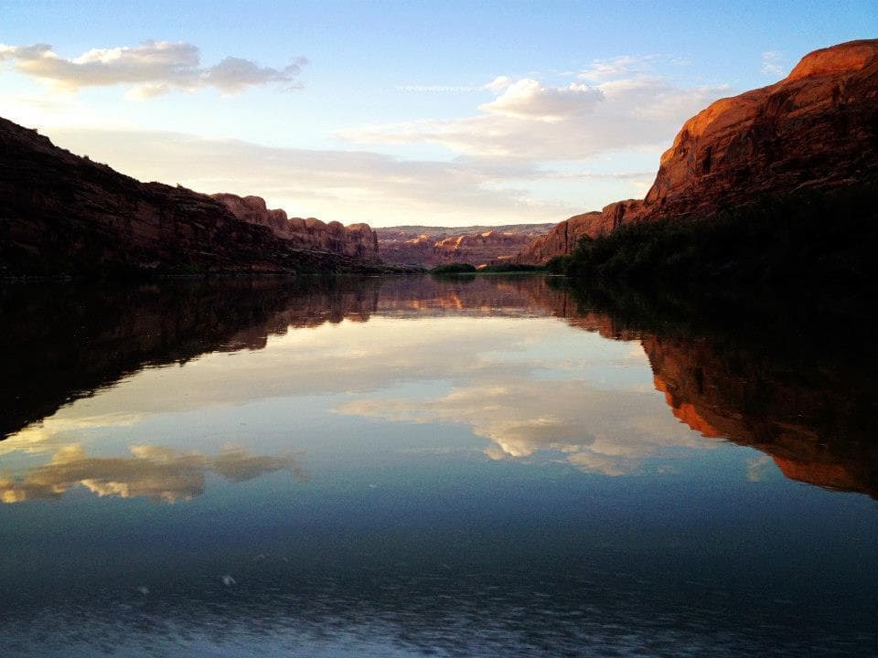 Sunset canyon reflection on calm river in Canyonlands Utah