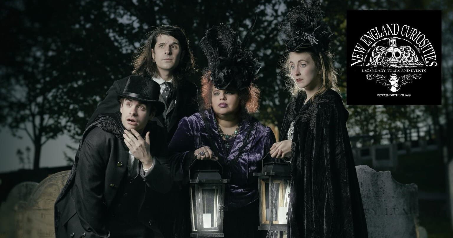 Guided lantern ghost tour group posing in historic cemetery at dusk
