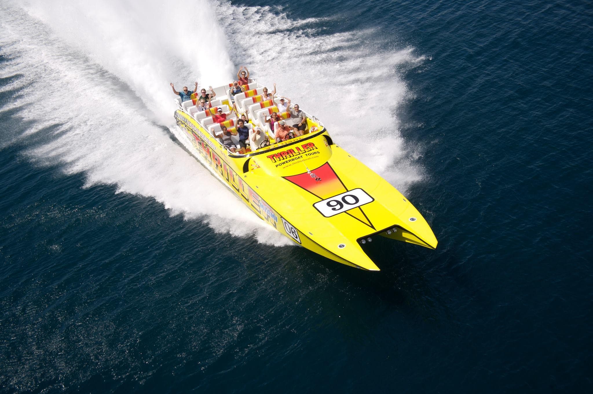Aerial action shot of high-speed powerboat leaving white wake