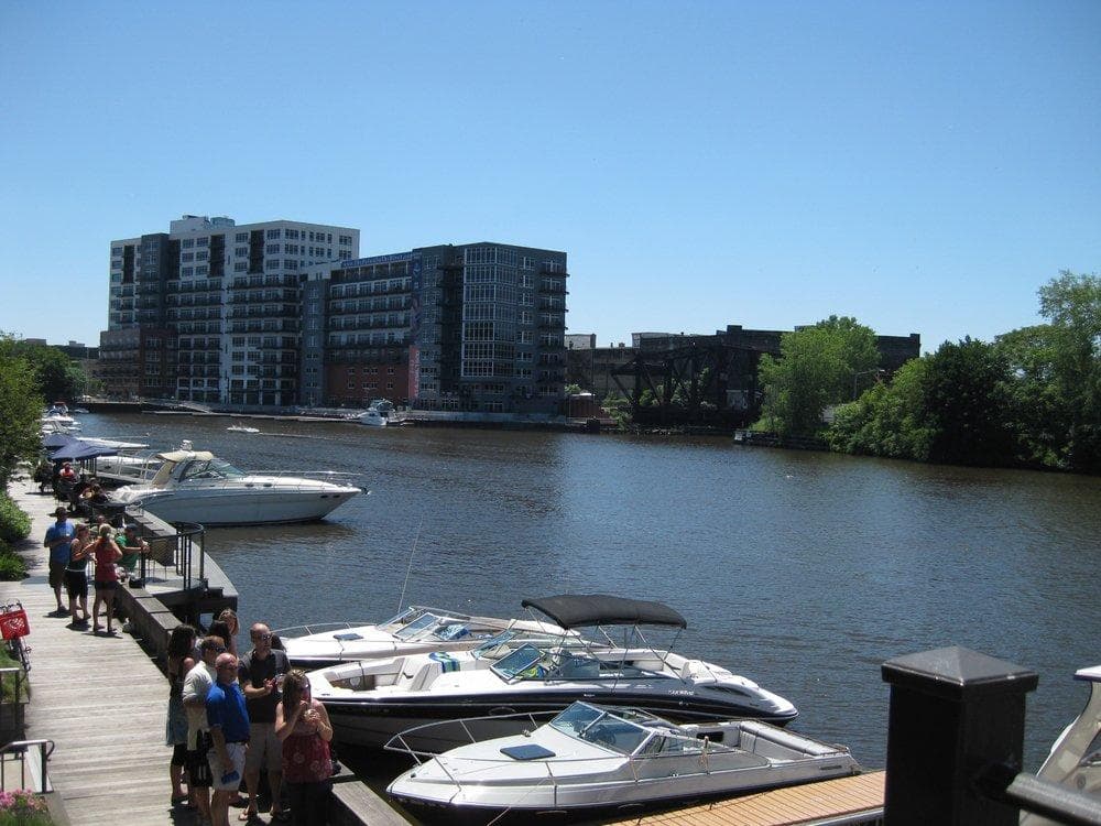 Marina promenade with pleasure boats along city river