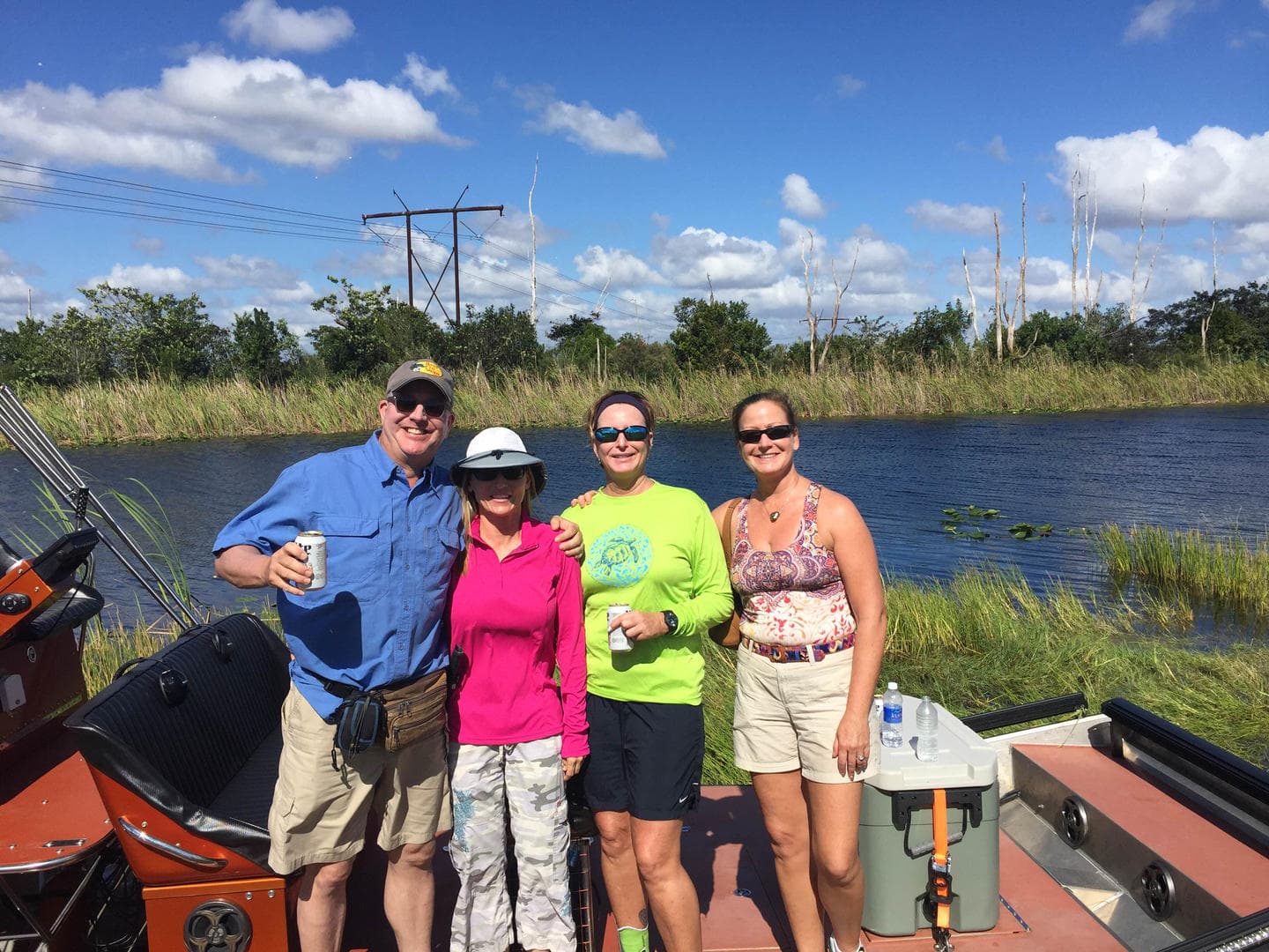 Group posing on an Everglades airboat tour beside marsh waters