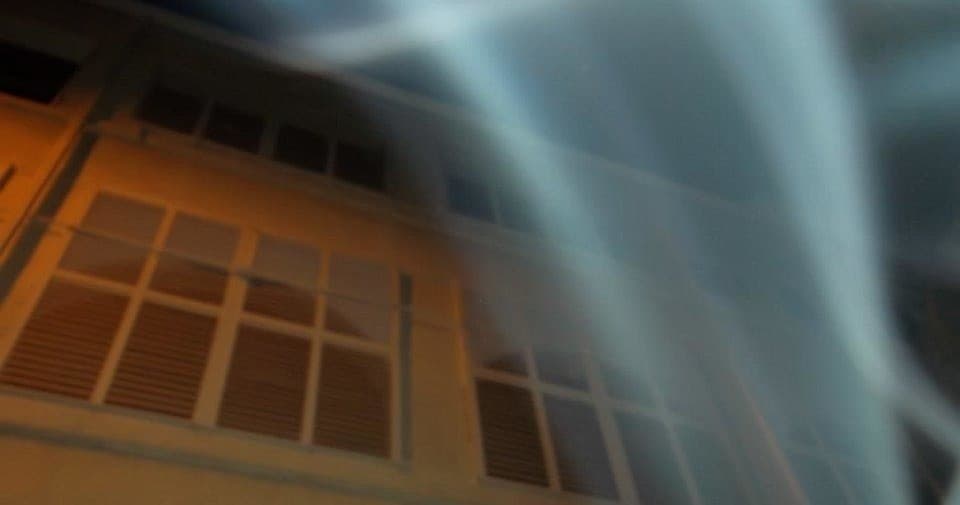 Ethereal light beams over historic Key West building at night