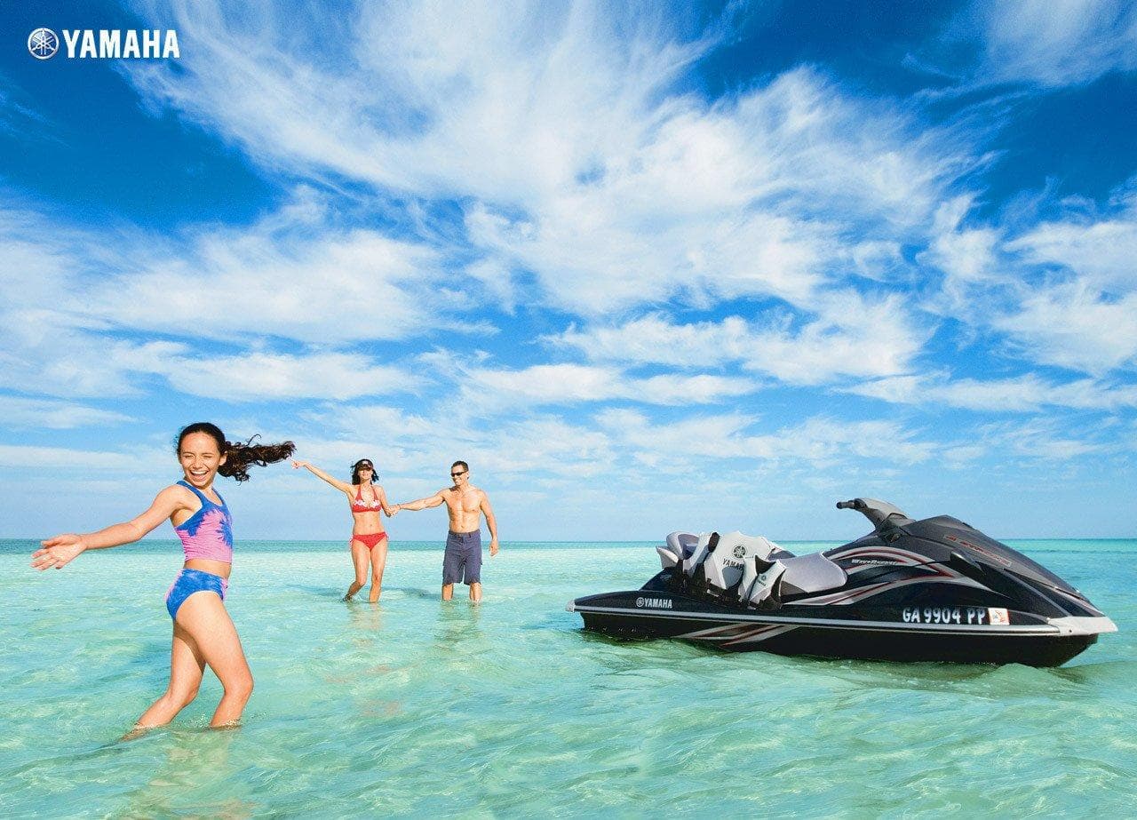 Group jet ski and beachgoers on turquoise Caribbean waters