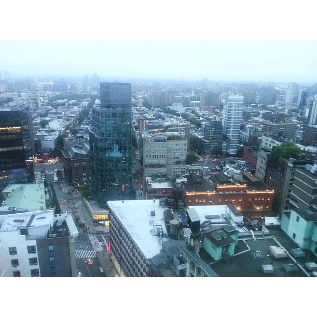 Aerial rooftop view of city skyline and urban rooftops at dusk