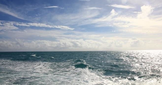 Open ocean view from cruise boat with sparkling water horizon