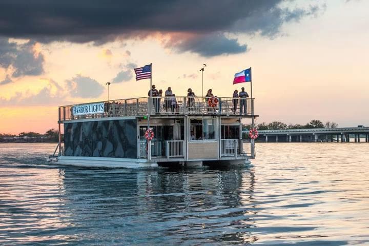 Sightseeing paddleboat cruising at sunset with passengers onboard