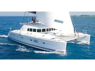 Luxury catamaran cruising calm turquoise waters near shore