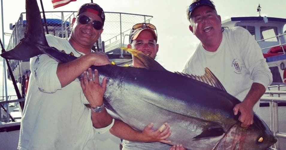 Crew lifting giant yellowfin tuna on Miami sportfishing charter deck