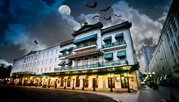 Moonlit historic hotel facade on haunted San Antonio street tour