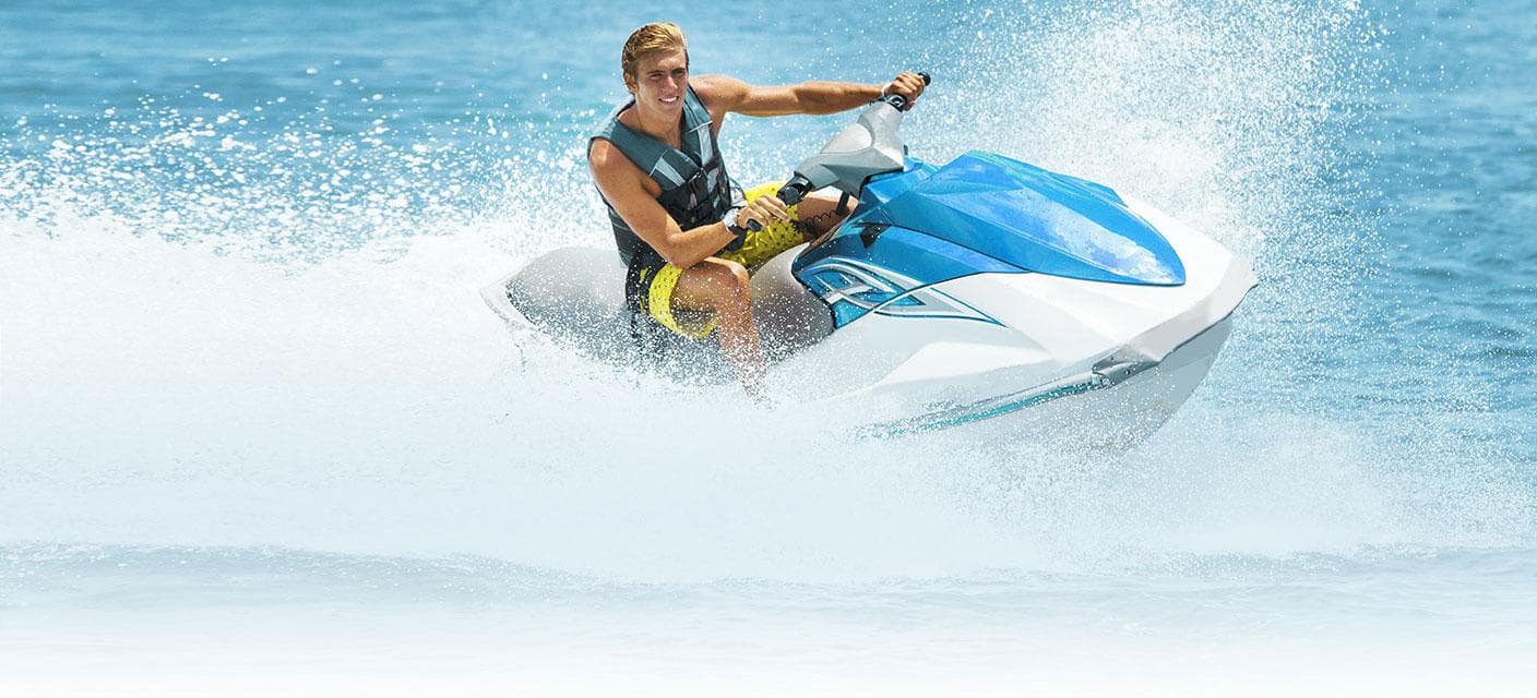 Jet ski rider cutting through ocean spray near Key West shoreline