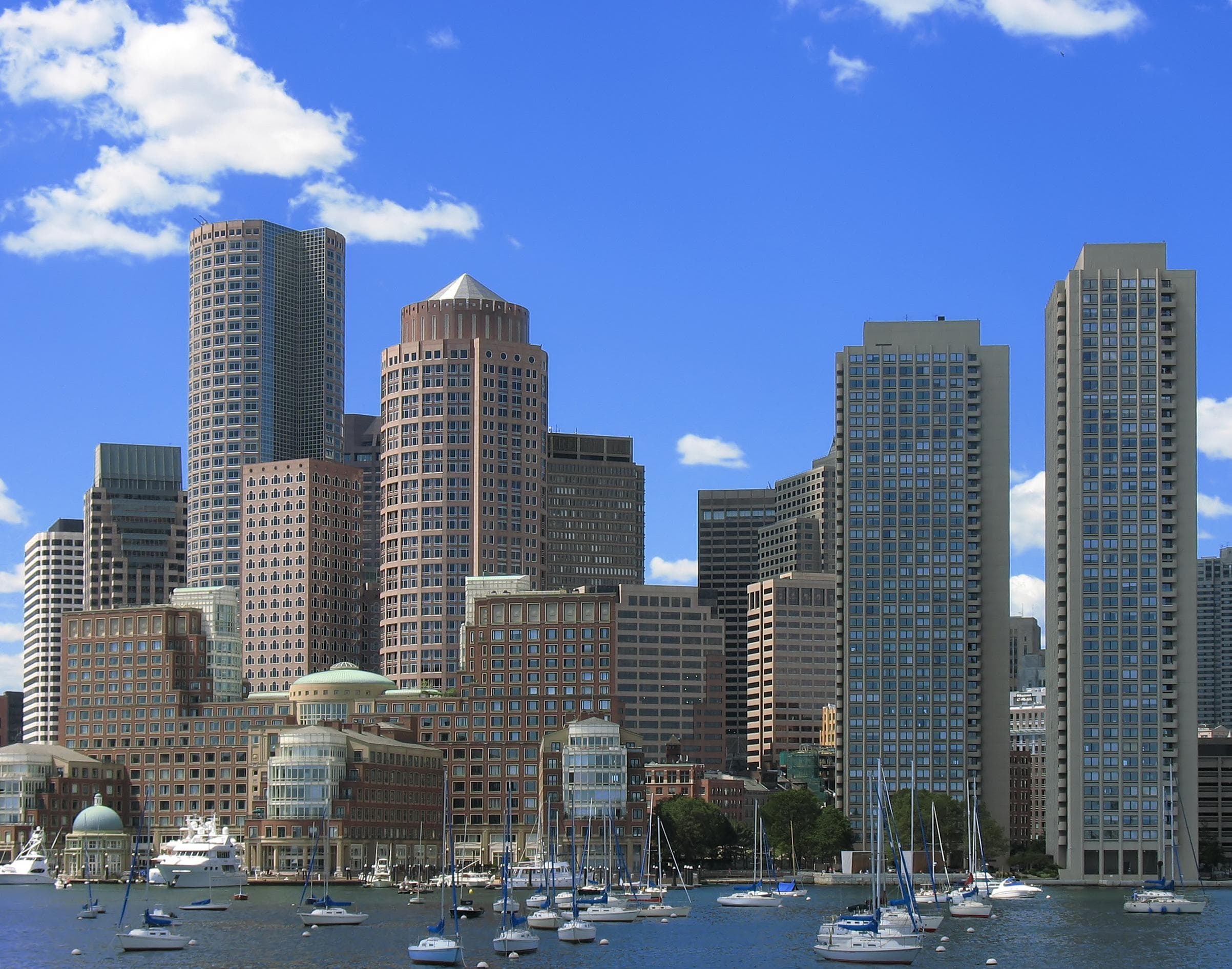 Boston waterfront skyline viewed from harbor with moored boats