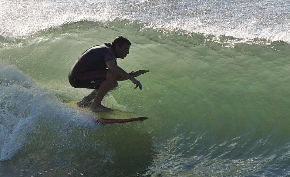 Surfer carving inside green wave on ocean ride